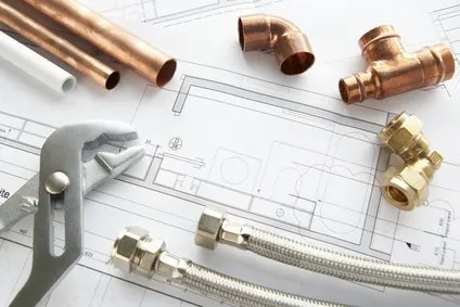 Copper pipes and tools on a construction drawing